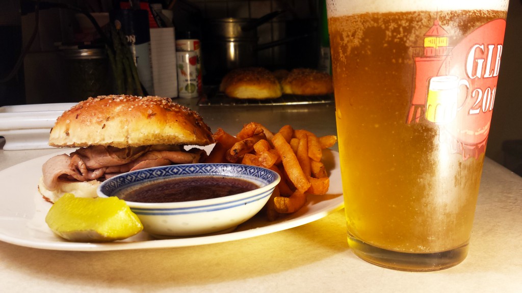 Beef on weck, with pickle, fries, jus, and beer.
