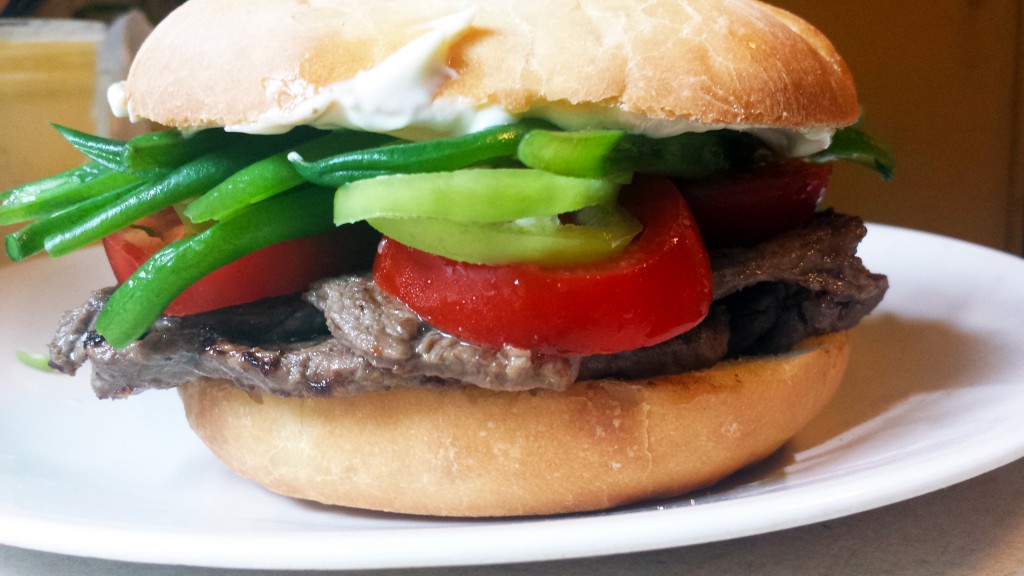 Chacarero with steak, tomatoes, Hungarian wax peppers, green beans and mayonnaise on pan amasado