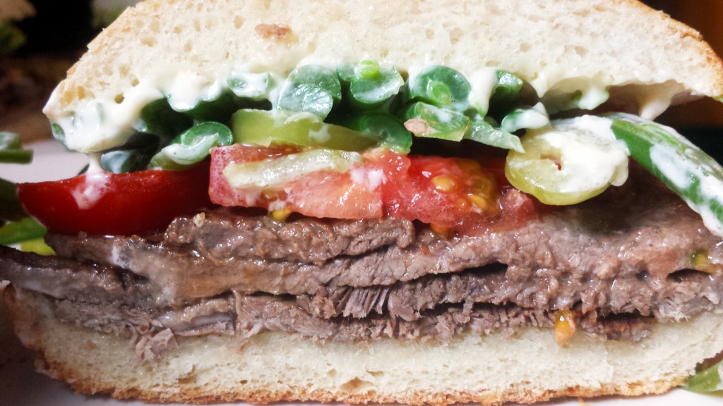 Chacarero with sirloin steak, tomato, Hungarian wax pepper, green beans, and mayonnaise on pan amasado