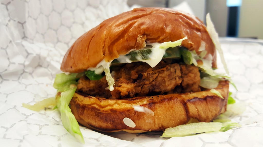 Leghorn Nashville Hot thigh on a bun, with mayo, tomato, and lettuce