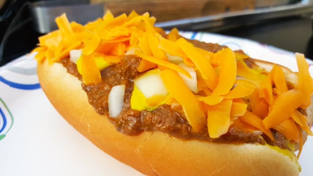 Chili cheddar dog with mustard and onion