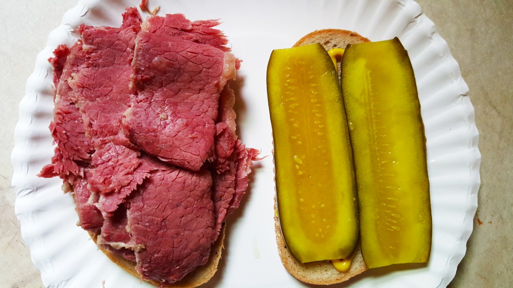 My homemade corned beef, with pickle and yellow mustard, on seeded rye