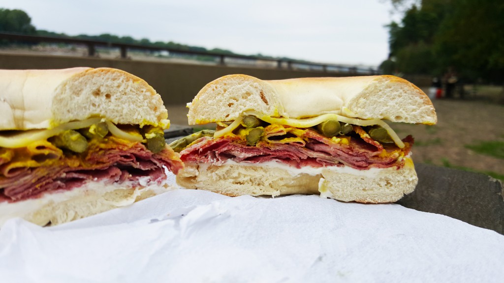 Salt beef tongue bagel with cream cheese, English mustard, pickled asparagus, and horseradish cheddar