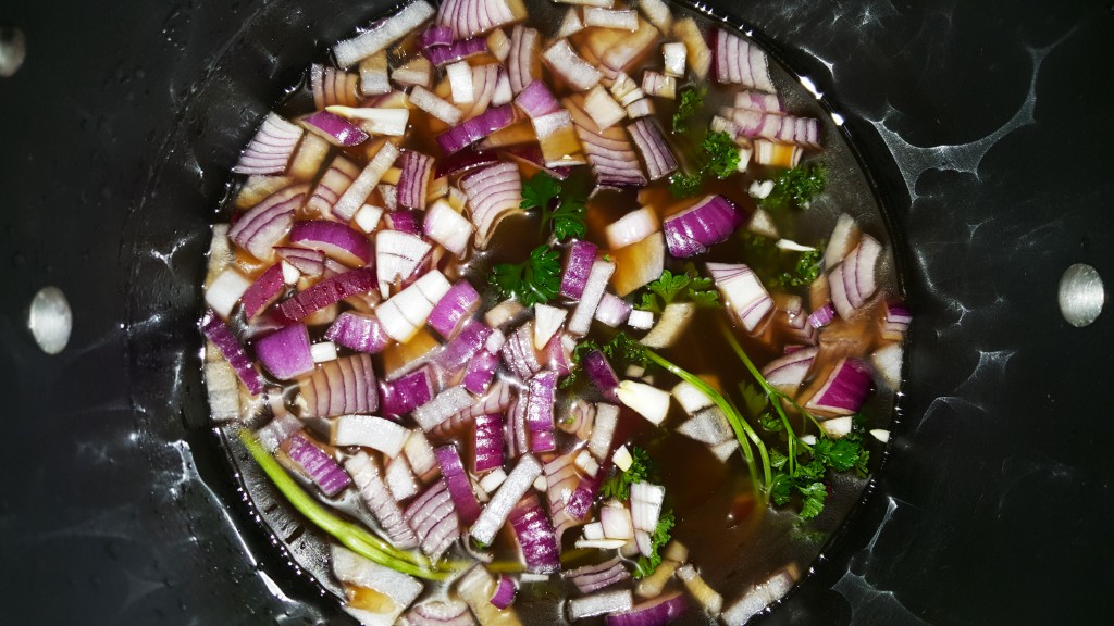 Simmering onions and parsley in stock