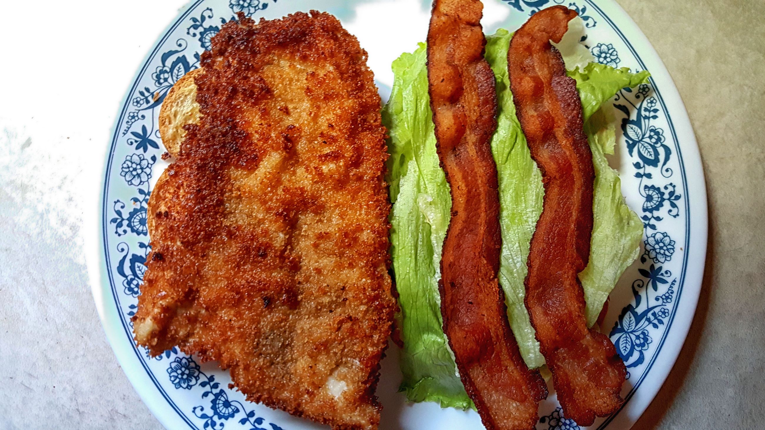 Chicken schnitzel with mayo, lettuce, and bacon