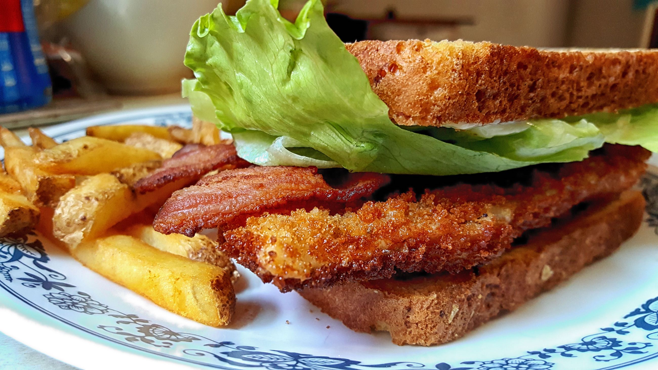 Chicken schnitzel with mayo, lettuce, and bacon