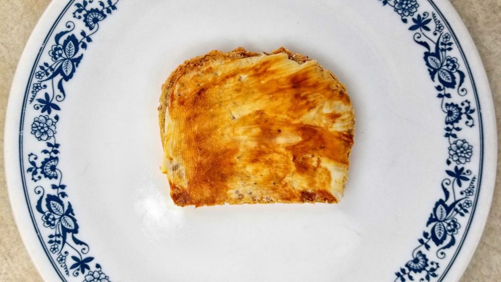 Marmite and butter on multi-grain bread