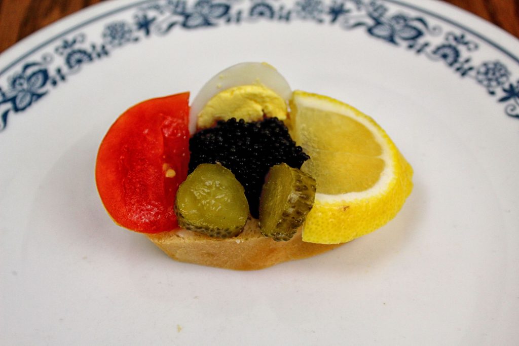 Caviar with egg, tomato, lemon, pickle