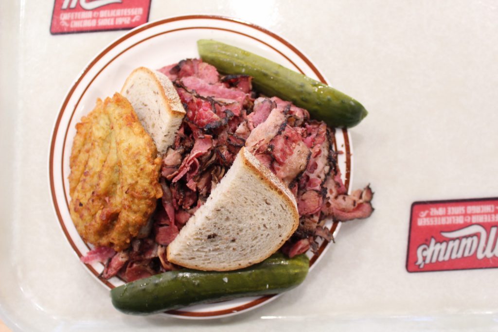 Pastrami sandwich with pickle and potato pancake