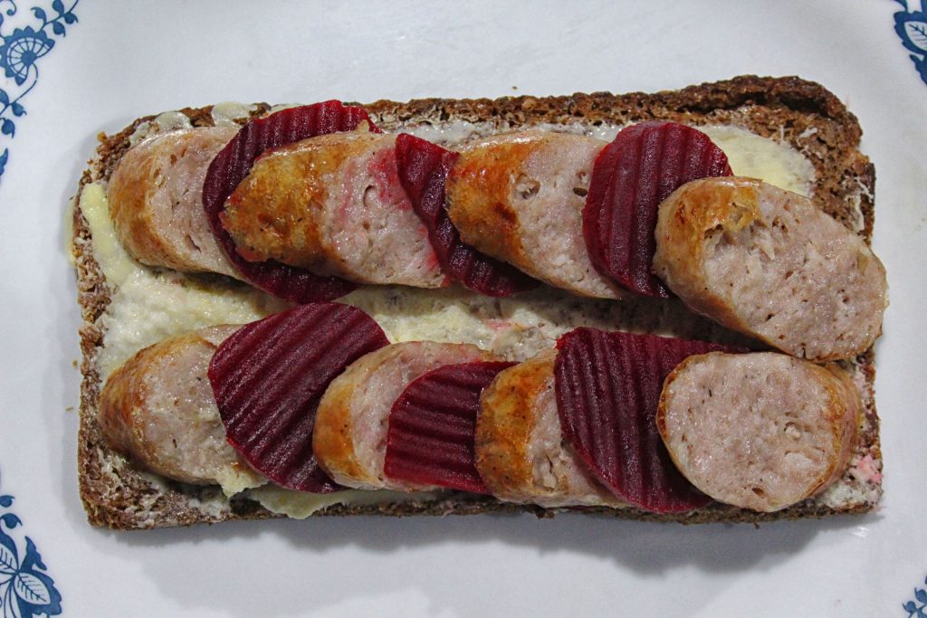 Swedish potato sausage and pickled beets on buttered rye bread