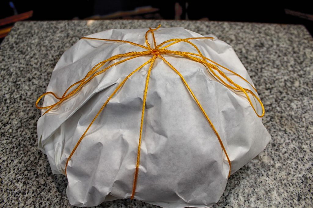 Wrapped in butcher paper, tied with twine