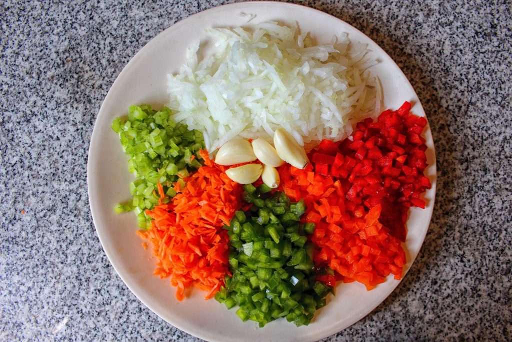 Onion, red orange and green bell pepper, carrot, celery, and garlic